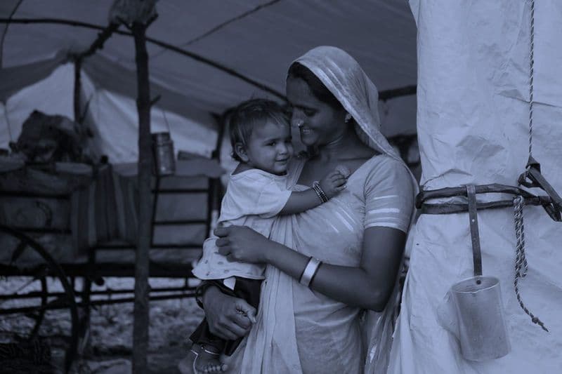 Mother holding a child — Fortify Health works to prevent anaemia through food fortification